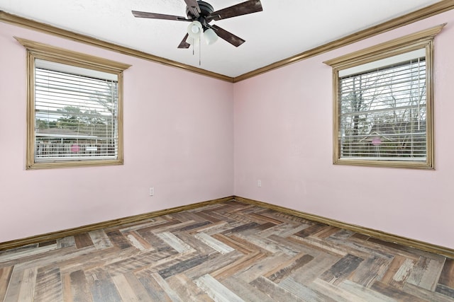 spare room with ceiling fan, baseboards, and crown molding