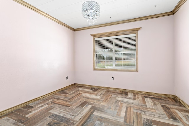 spare room with a chandelier, baseboards, and crown molding