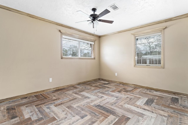 empty room featuring ceiling fan, crown molding, visible vents, and a textured ceiling