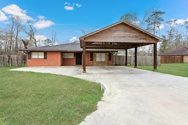 view of front of home featuring a front yard, concrete driveway, and fence