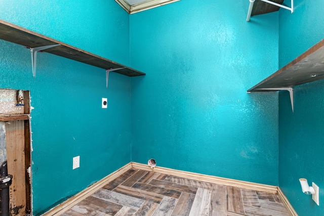 washroom with parquet floors, laundry area, baseboards, and electric dryer hookup