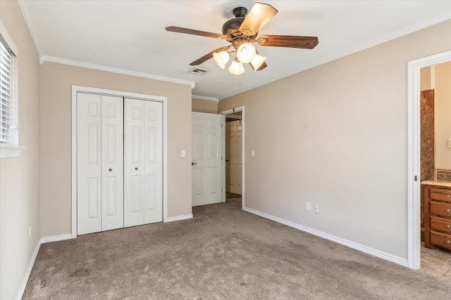 unfurnished bedroom with ensuite bath, ornamental molding, light colored carpet, ceiling fan, and a closet