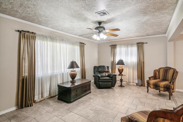 living area with ceiling fan and ornamental molding