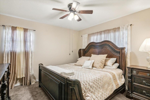 bedroom with dark colored carpet and ceiling fan