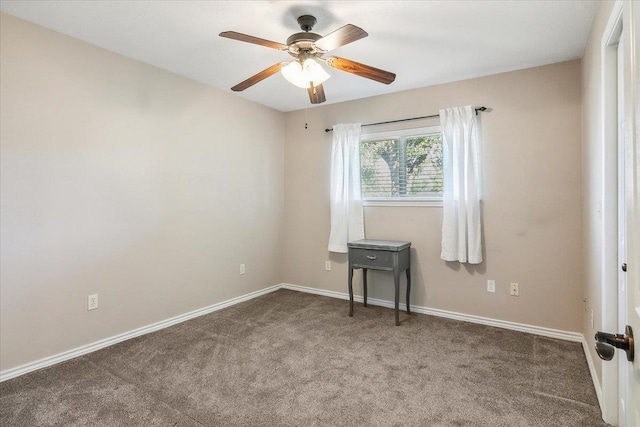 carpeted spare room featuring ceiling fan