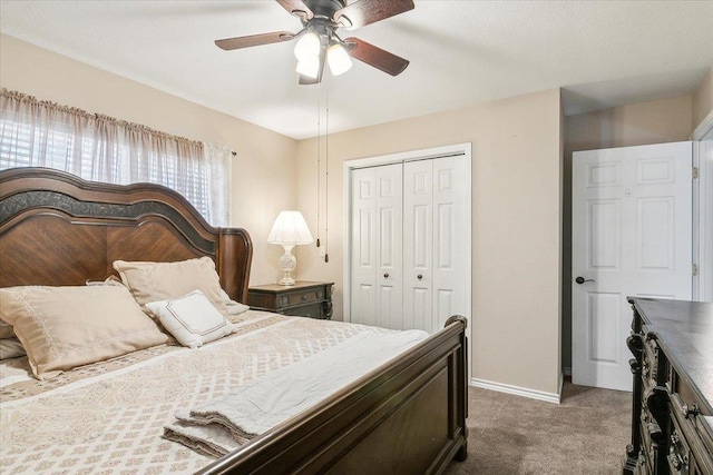 carpeted bedroom featuring ceiling fan and a closet