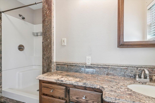 bathroom with vanity and walk in shower