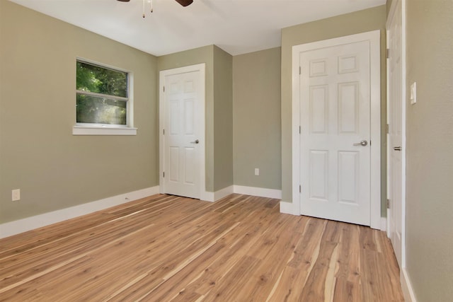 1105 W Dr, Port Neches, TX 77651 - unfurnished bedroom with light wood-type flooring, baseboards, and ceiling fan