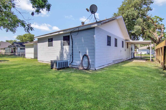 1105 W Dr, Port Neches, TX 77651 - rear view of property with an attached carport and cooling unit