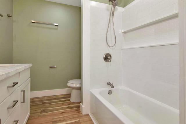 1105 W Dr, Port Neches, TX 77651 - bathroom featuring toilet, vanity, wood finished floors, bathing tub / shower combination, and baseboards