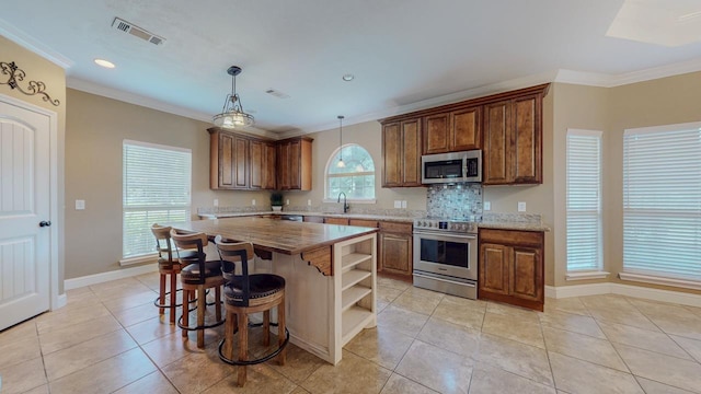 13475 Chimney Rock Dr, Beaumont, TX 77713 - kitchen with stainless steel appliances, open shelves, light tile patterned flooring, hanging light fixtures, and decorative backsplash