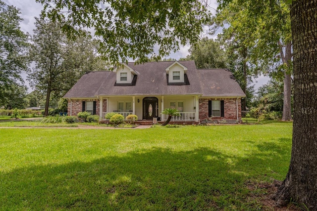 13475 Chimney Rock Dr, Beaumont, TX 77713 - cape cod house featuring a porch, a front lawn, and brick siding
