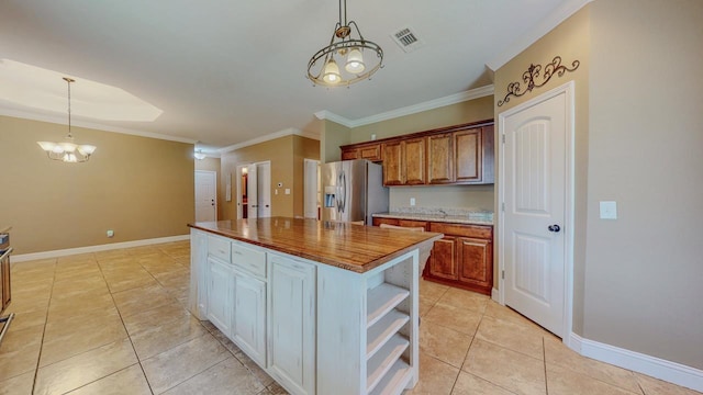 13475 Chimney Rock Dr, Beaumont, TX 77713 - kitchen featuring stainless steel fridge, a chandelier, light tile patterned floors, decorative light fixtures, and crown molding