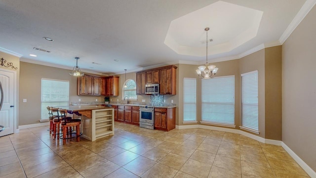 13475 Chimney Rock Dr, Beaumont, TX 77713 - kitchen featuring stainless steel appliances, light countertops, open shelves, crown molding, and a kitchen island