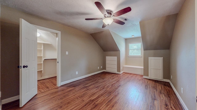 13475 Chimney Rock Dr, Beaumont, TX 77713 - additional living space featuring wood finished floors, a ceiling fan, lofted ceiling, and a textured ceiling