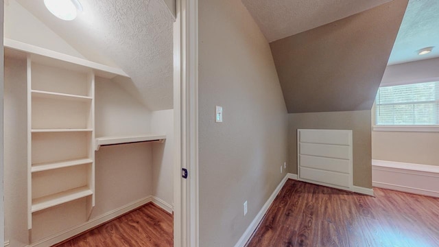 13475 Chimney Rock Dr, Beaumont, TX 77713 - bonus room featuring vaulted ceiling, wood finished floors, and a textured ceiling