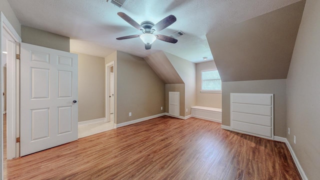 13475 Chimney Rock Dr, Beaumont, TX 77713 - additional living space featuring wood finished floors, a ceiling fan, a textured ceiling, and lofted ceiling