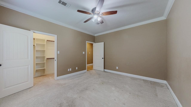13475 Chimney Rock Dr, Beaumont, TX 77713 - unfurnished bedroom featuring carpet flooring, ornamental molding, a walk in closet, a closet, and ceiling fan
