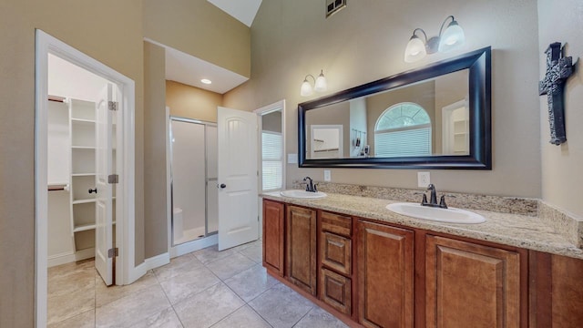 13475 Chimney Rock Dr, Beaumont, TX 77713 - full bathroom featuring a stall shower, a walk in closet, double vanity, and tile patterned floors