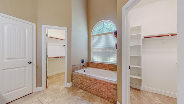 13475 Chimney Rock Dr, Beaumont, TX 77713 - full bathroom with a bath, a walk in closet, and tile patterned flooring