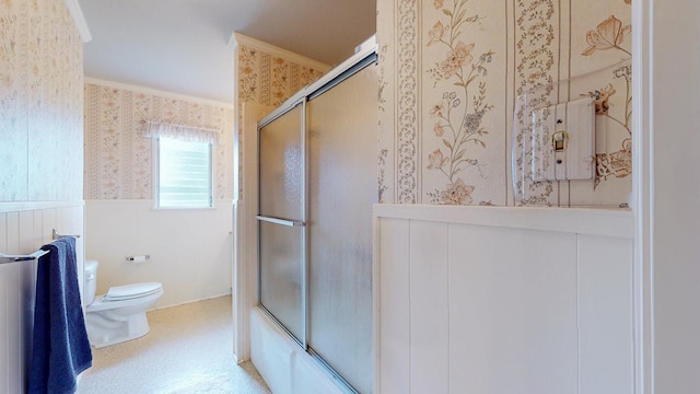 6225 Pansy Dr, Beaumont, TX 77706 - bathroom with wallpapered walls, a wainscoted wall, and shower / bath combination with glass door