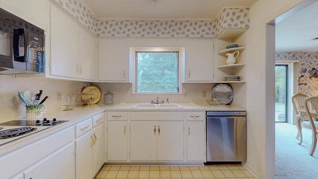 6225 Pansy Dr, Beaumont, TX 77706 - kitchen with stainless steel dishwasher, black microwave, wallpapered walls, light countertops, and open shelves