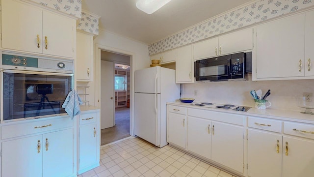 6225 Pansy Dr, Beaumont, TX 77706 - kitchen with white appliances, crown molding, light countertops, and light tile patterned flooring