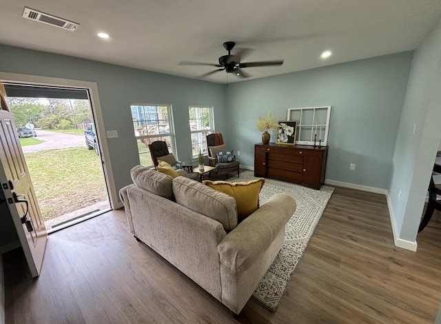 living room featuring hardwood / wood-style flooring and ceiling fan