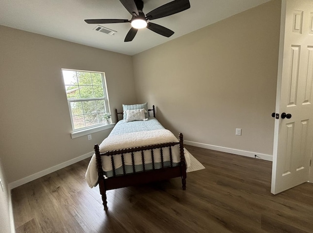 bedroom with ceiling fan and dark hardwood / wood-style flooring