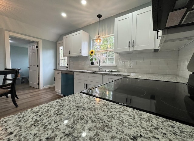 kitchen with light stone countertops, dishwashing machine, sink, white cabinetry, and lofted ceiling