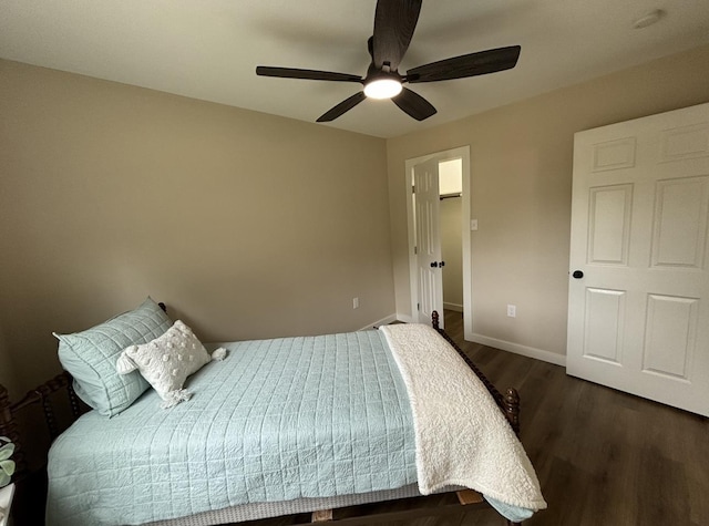 bedroom with dark hardwood / wood-style flooring and ceiling fan