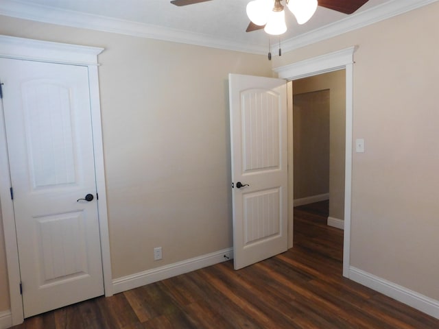 unfurnished bedroom featuring baseboards, dark wood finished floors, a ceiling fan, and crown molding