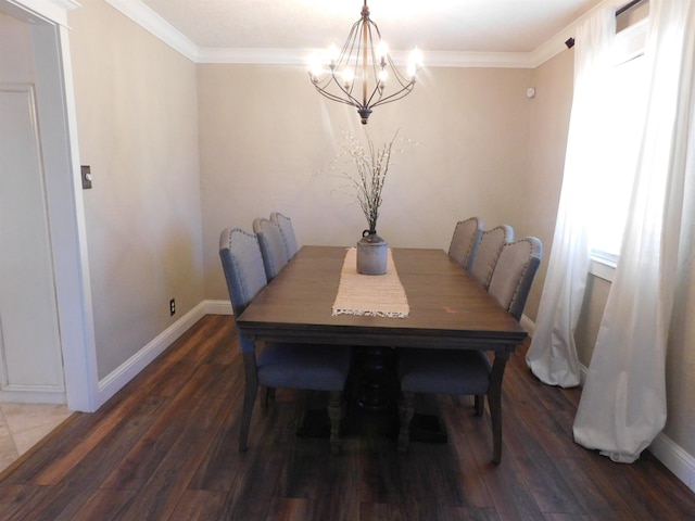 dining room featuring crown molding, baseboards, and wood finished floors