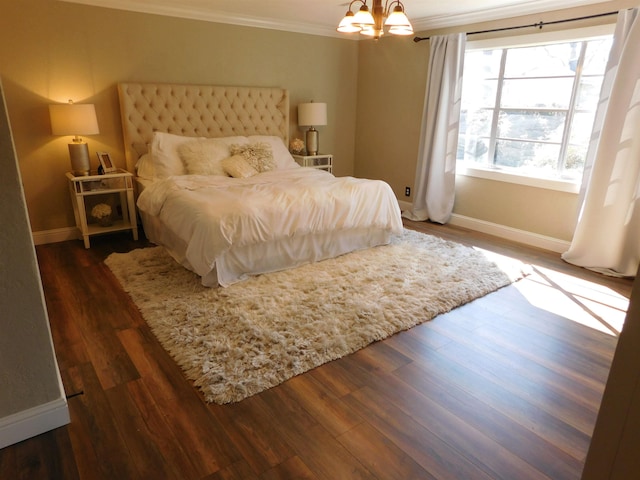 bedroom featuring ornamental molding, a chandelier, dark wood-type flooring, and baseboards