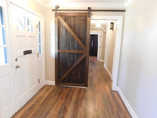 entryway with baseboards, wood finished floors, and crown molding