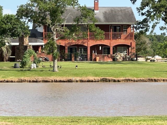 10994 Bessie Heights Rd, Orange, TX 77630 - rear view of property with a yard, a water view, and a chimney