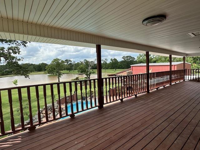 10994 Bessie Heights Rd, Orange, TX 77630 - wooden terrace with a water view and a lawn