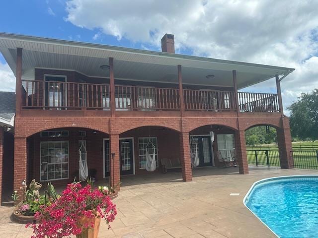 10994 Bessie Heights Rd, Orange, TX 77630 - rear view of house with a patio area, a chimney, and a balcony