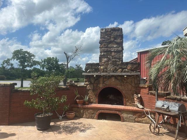 10994 Bessie Heights Rd, Orange, TX 77630 - view of patio / terrace with an outdoor stone fireplace