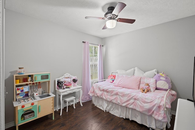6605 Palace Dr, Lumberton, TX 77657 - bedroom featuring dark wood-type flooring, a textured ceiling, ceiling fan, and baseboards