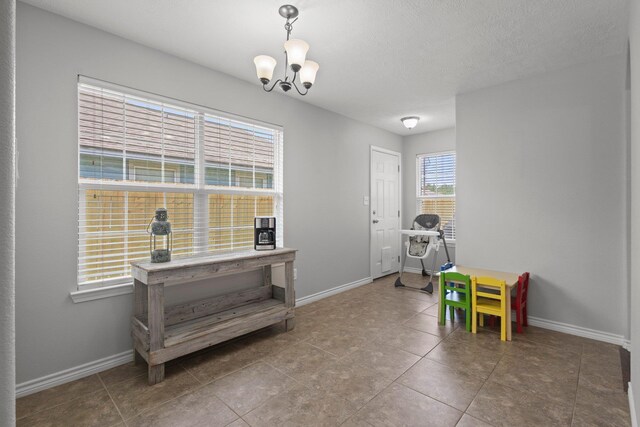 6605 Palace Dr, Lumberton, TX 77657 - game room with a chandelier, baseboards, and tile patterned flooring