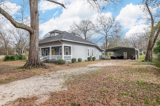 view of property exterior with a carport and a porch