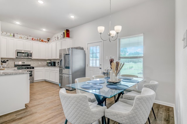 1560 Alice Dr, Beaumont, TX 77705 - dining area with light wood finished floors, a chandelier, lofted ceiling, baseboards, and recessed lighting