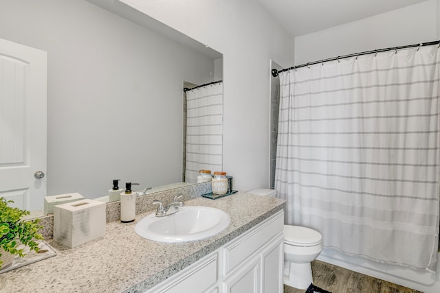 1560 Alice Dr, Beaumont, TX 77705 - full bath featuring vanity, wood finished floors, and toilet