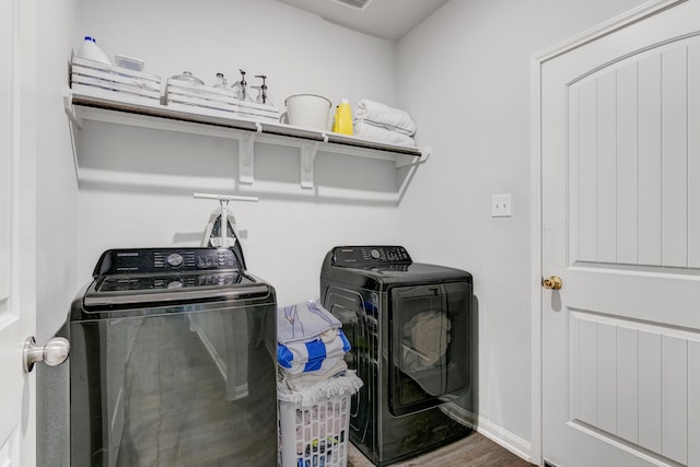 1560 Alice Dr, Beaumont, TX 77705 - laundry room with independent washer and dryer and wood finished floors