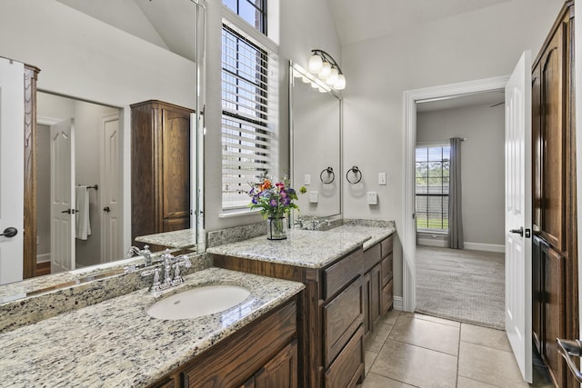 bathroom featuring vanity, tile patterned flooring, and lofted ceiling