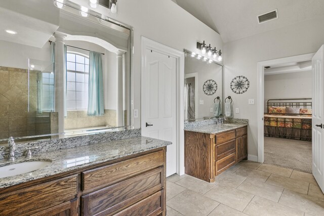 bathroom with vanity, an enclosed shower, vaulted ceiling, tile patterned floors, and ornate columns