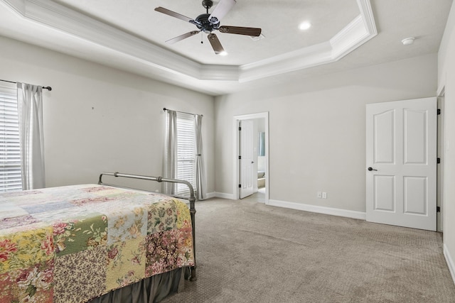 bedroom featuring crown molding, ceiling fan, a raised ceiling, and light carpet