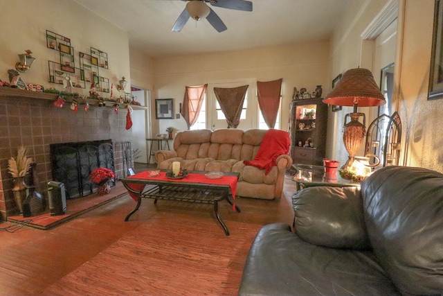 living room featuring a fireplace, hardwood / wood-style floors, and ceiling fan