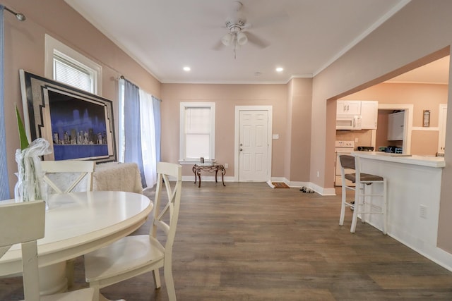 dining room with ceiling fan, dark hardwood / wood-style flooring, and ornamental molding